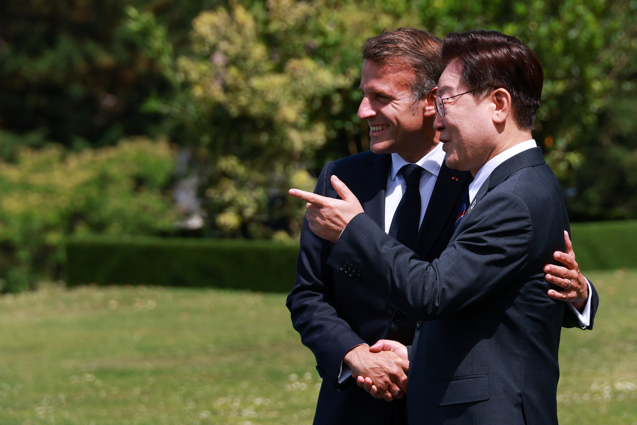 President Lee Jae Myung greets French President Emmanuel Macron, the chair of the summit, at the host country’s welcome reception for invited nations held at the Group of Seven summit venue in Évian-les-Bains, France on June 16 (local time).  (Yonhap)