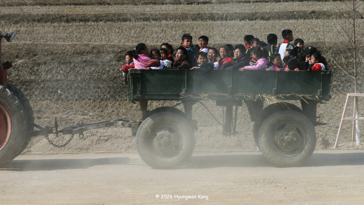 North Korean children and women during a tractor ride in North Pyongan Province, DPRK on April 12, 2026. (Hyungwon Kang)