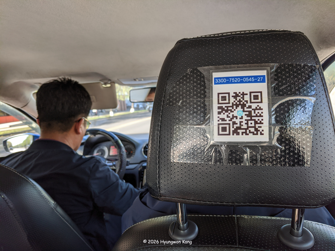 A QR code for digital payment is taped to the back of a taxi seat in Pyongyang, North Korea, on April 15, 2026.  (2026 Hyungwon Kang)
