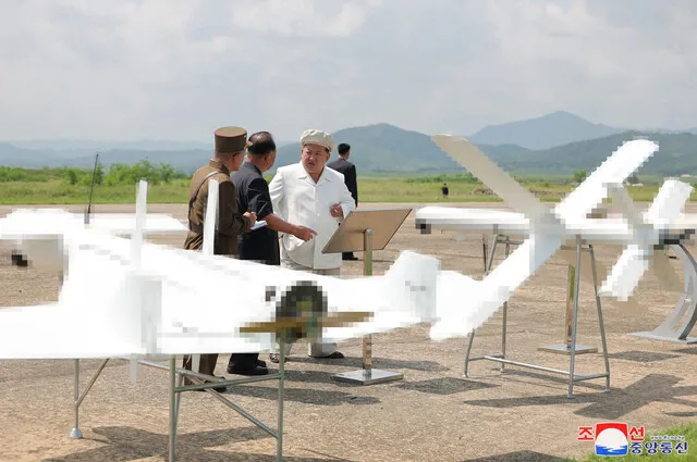 North Korean leader Kim Jong-un (in white) inspects the Drone Institute of the Academy of Defense Sciences in August 2024. (KCNA via Yonhap)