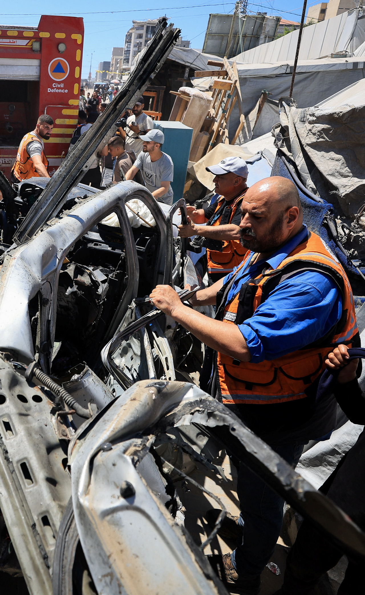 Palestinians inspect a vehicle hit in an Israeli strike, in Gaza City, June 18, 2026. REUTERS/Dawoud Abu Alkas