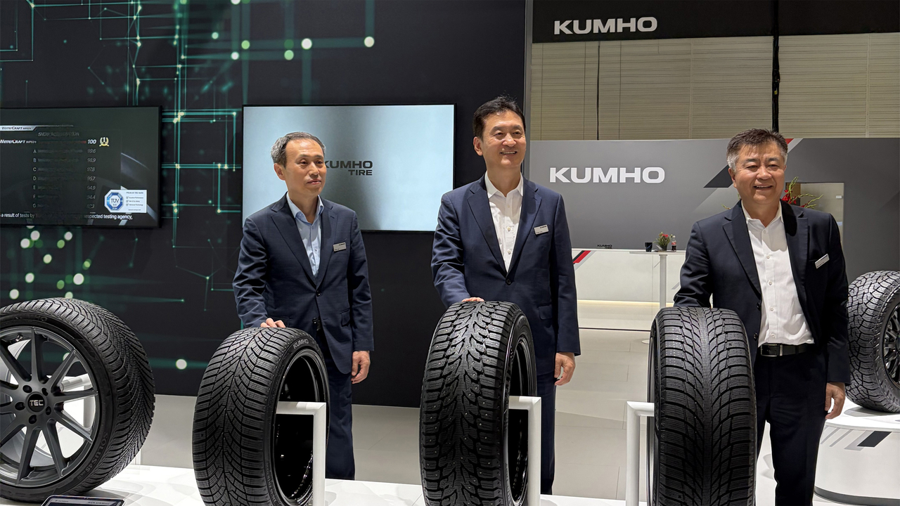 From left: Lee Gang-seung, head of Kumho Tire Europe; CEO Jung Il-taik; and Lim Seung-bin, vice president and head of global sales, pose alongside Kumho Tire products on display at Tire Cologne 2026 in Cologne, Germany. (Kumho Tire)