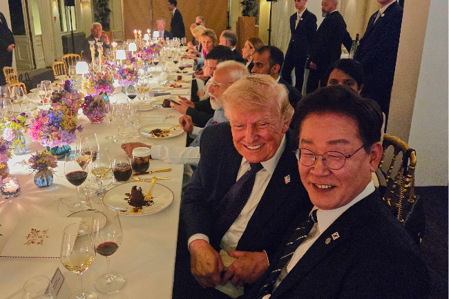 President Lee Jae Myung (front) and US President Donald Trump pose for a photo during an official dinner held on the sidelines of the Group of Seven summit in Evian-les-Bains, France, Tuesday. (Pool photo via Yonhap)