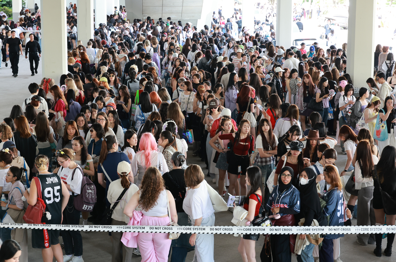 BTS fans wait in line outside an official merchandise booth before the group's concert at Busan Asiad Stadium on June 12. (Yonhap)