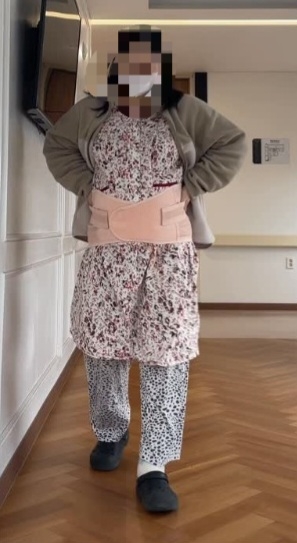 Kim walks at a postpartum care center while wearing a belly binder after giving birth by C-section. (Kim)