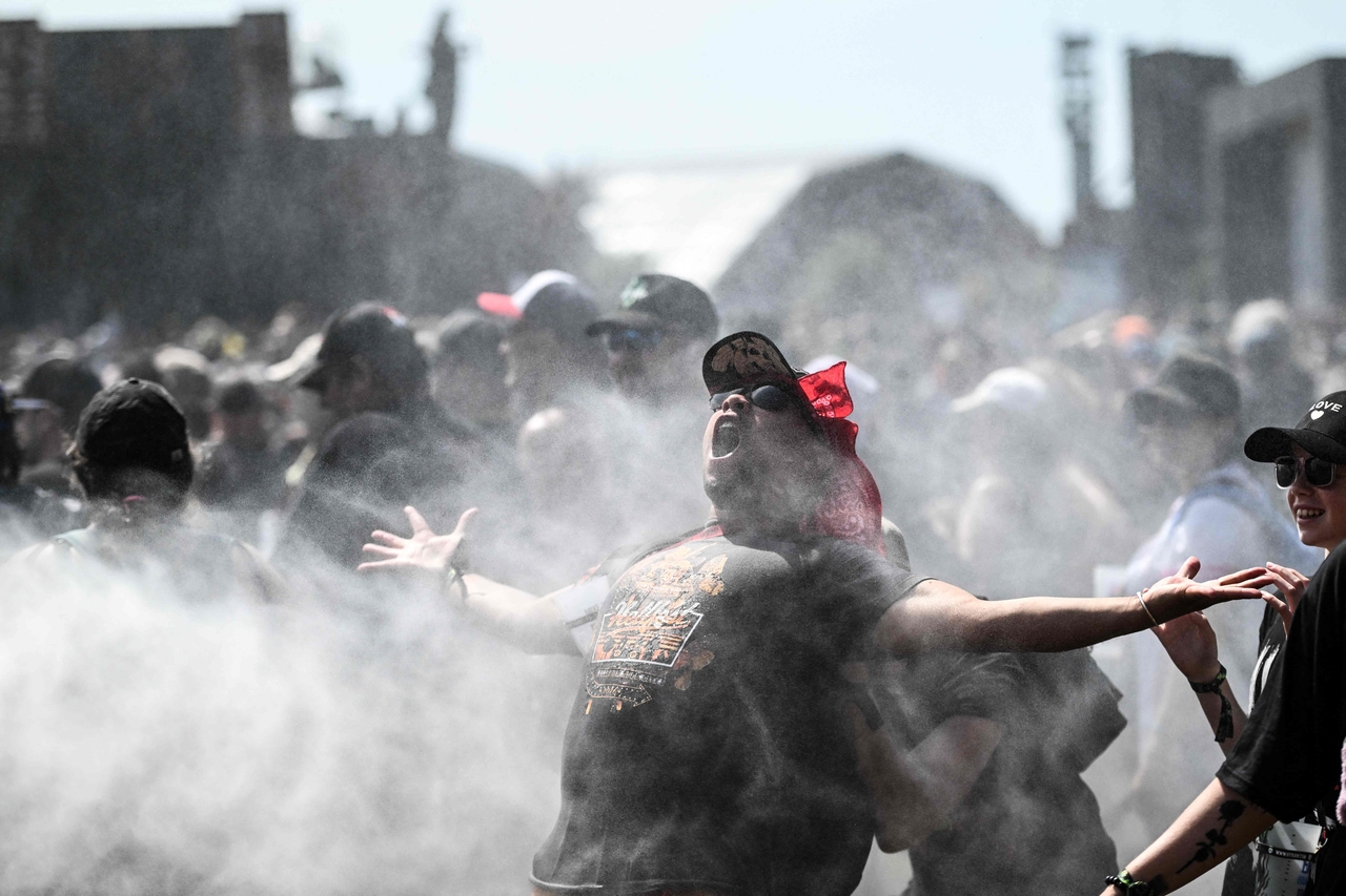 A person reacts while being sprayed with water at a musical festival in Clisson, France, Friday. (AFP-Yonhap)