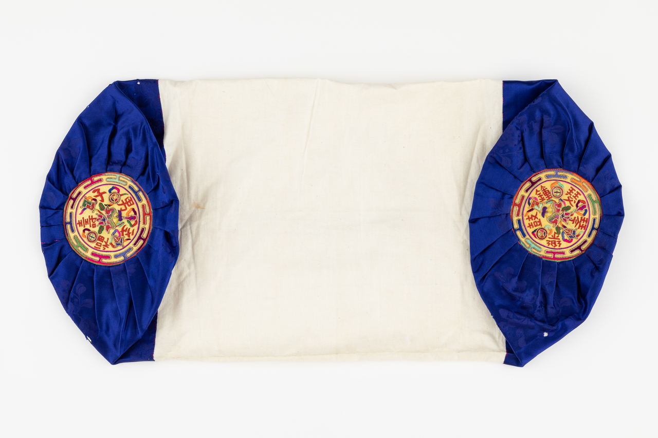 An embroidered pillow featuring auspicious motifs symbolizing marital harmony, longevity and abundant descendants. (Seoul Museum of Craft Art)