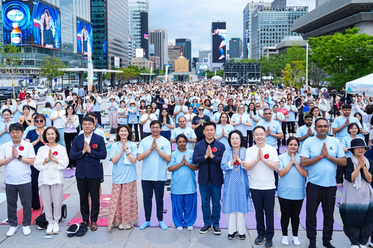 People participate in celebrations marking the International Day of Yoga at Seoul's Gwanghwamun Square on Sunday. (Embassy of India in Seoul)
