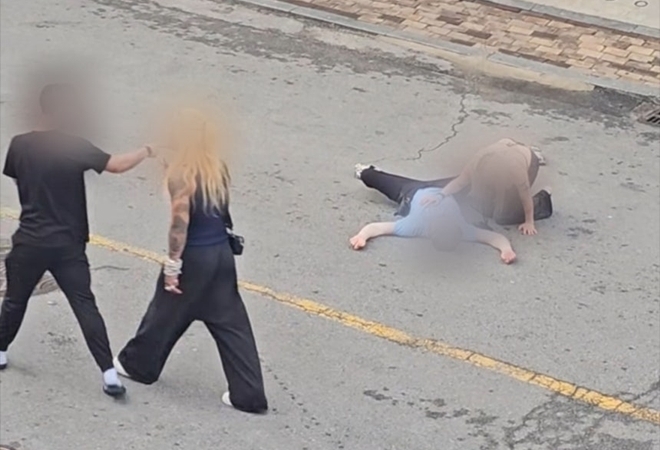 A video posted on social media shows a man lying on the ground after he was assaulted on a street in Sinjang-dong, a neighborhood adjacent to Osan Air Base in Pyeongtaek, Gyeonggi Province. (Facebook@Lovewena Reyes)