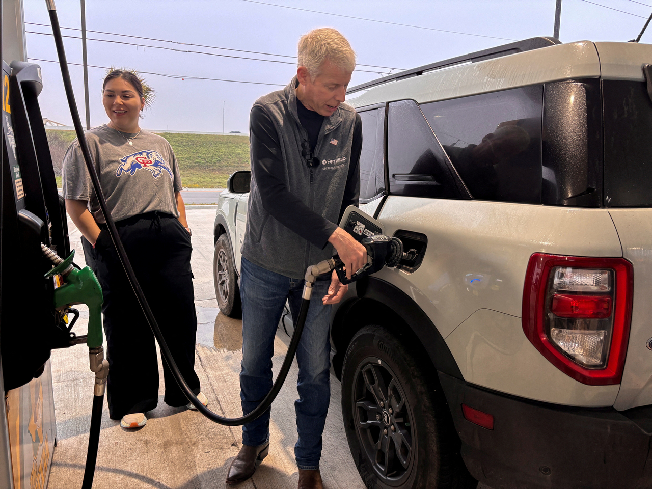 US Energy Secretary Chris Wright pumps gas at a Texas service station. [Reuters]