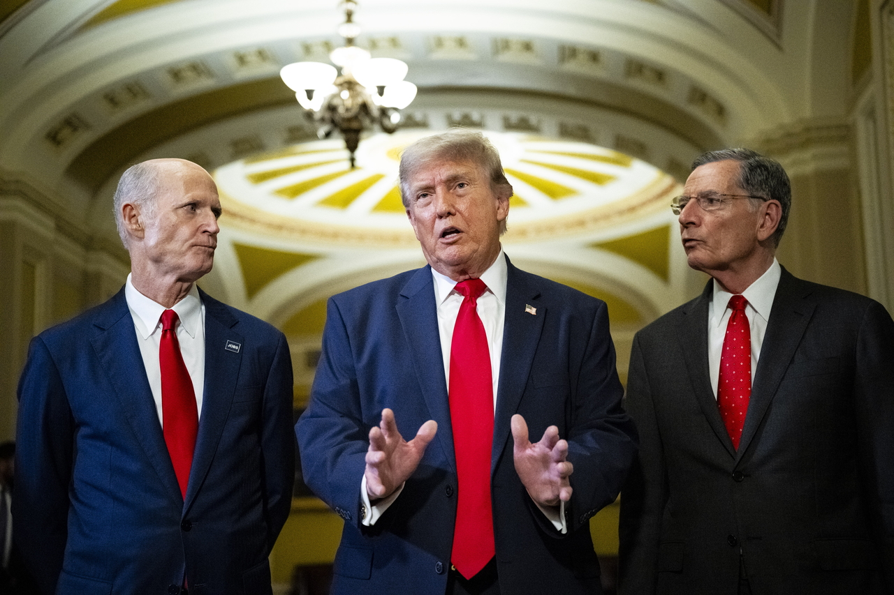 US President Donald Trump (center) speaks to the media with Republican Sens. Rick Scott (left) and John Barrasso after a luncheon meeting in Washington on Wednesday. (EPA-Yonhap)