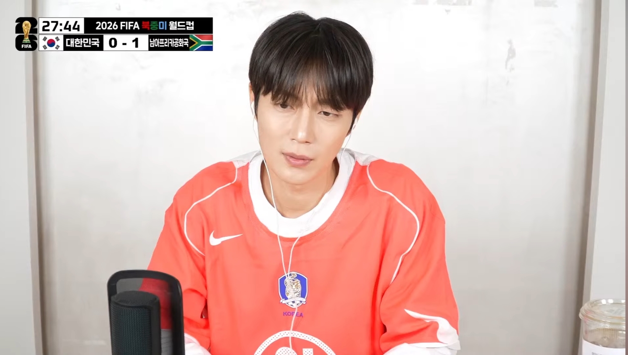 Yoon Doo-joon of Highlight reacts while watching South Korea’s World Cup match against South Africa on the boy group’s YouTube channel, Thursday. (Highlight’s YouTube channel)