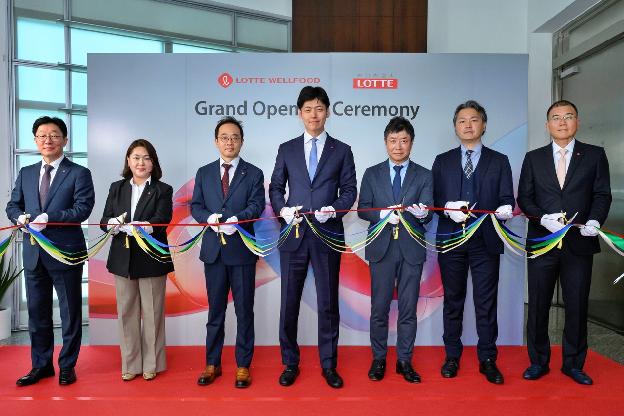 Shin Yoo-yeol, head of future growth at Lotte Group (center), and other executives pose at the opening ceremony for the office of Lotte's Singapore joint venture in May. (Lotte)