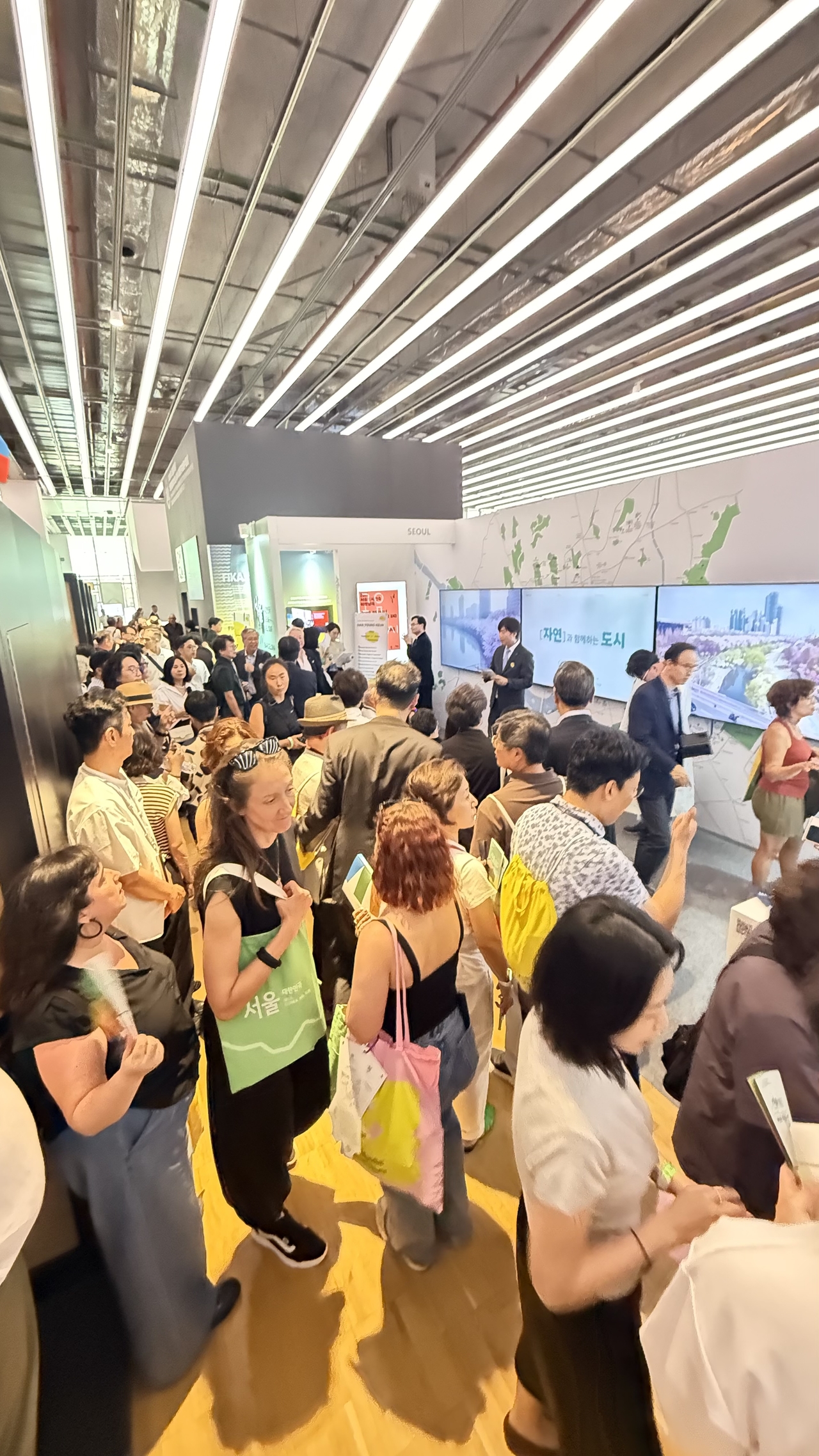 Participants browse the exhibition pavilion on Seoul architecture at the 2026 UIA World Congress of Architects in Barcelona, Spain, Monday. (Seoul Metropolitan Government)