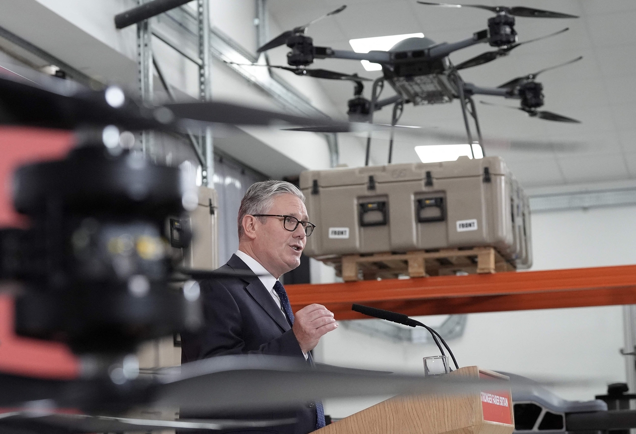 Britain’s Prime Minister Keir Starmer stands beneath display of UAV drones, as he delivers a speech in London Tuesday. (AFP-Yonhap)