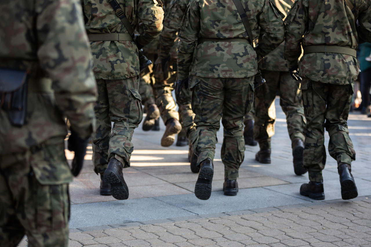 Rear view of marching soldiers in full uniform. (1234rf)