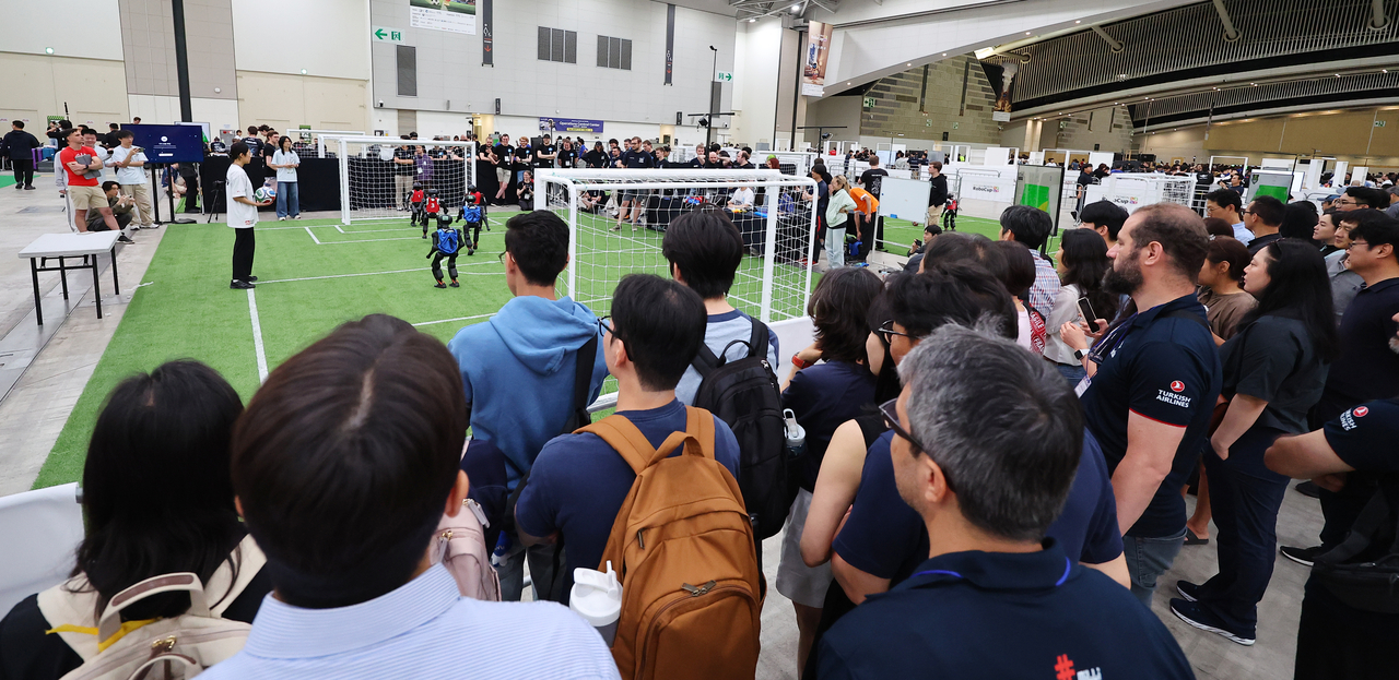 Spectators watch a robot soccer match at RoboCup 2026 Incheon. (Yonhap)