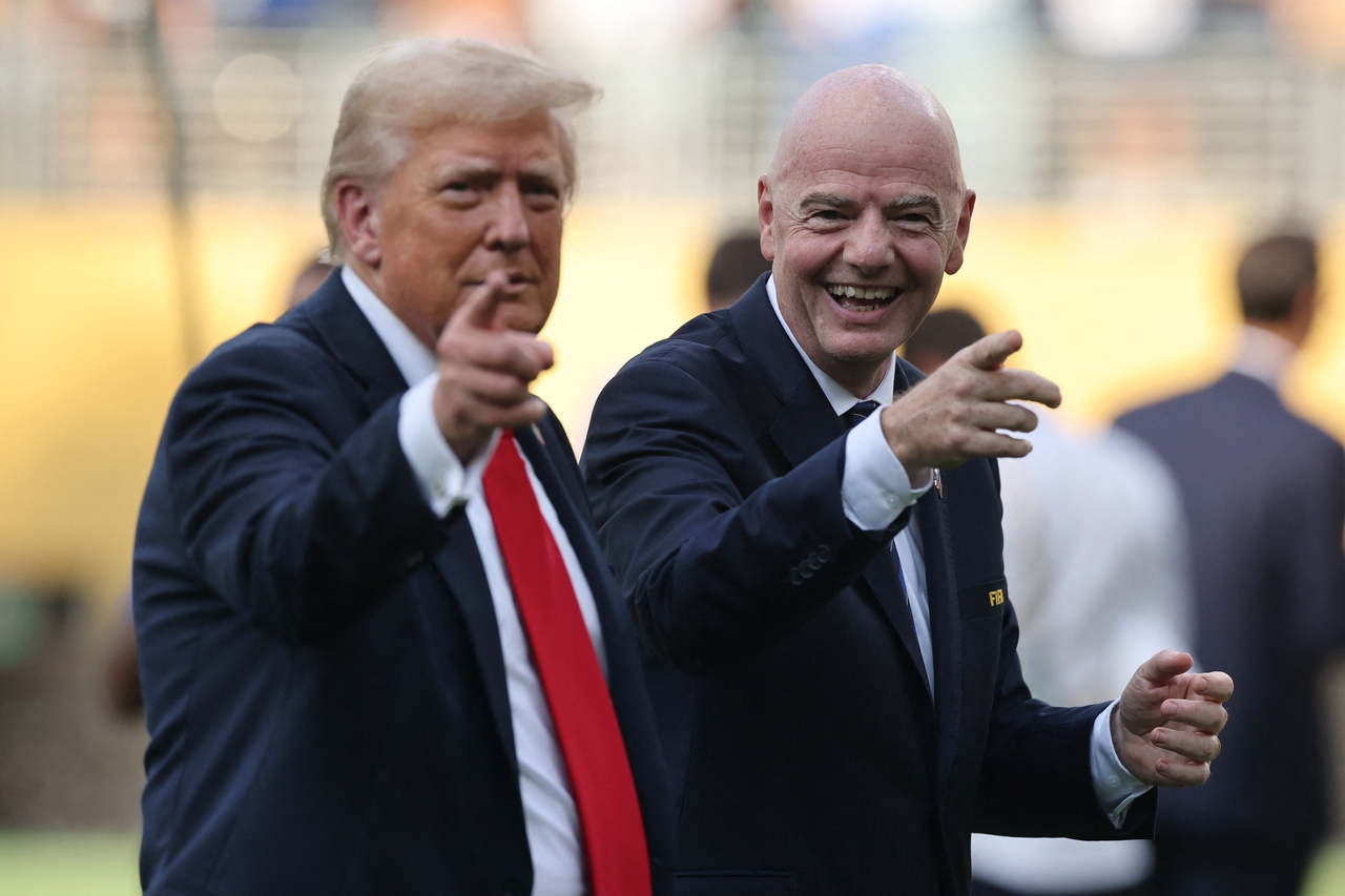 President Donald Trump speaks with FIFA President Gianni Infantino. [AFP]