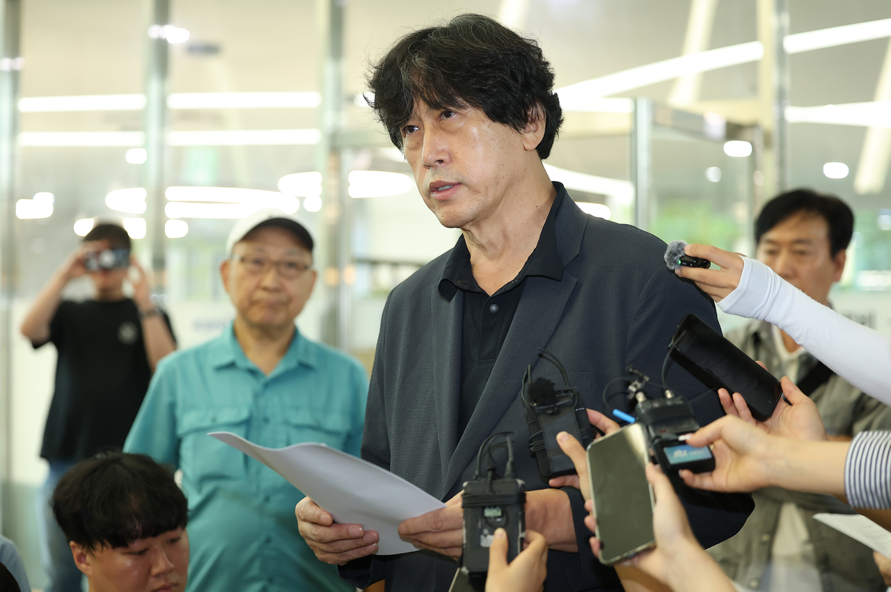 Kim Dong-yeon, head of the Paichai Academy Alumni Association, reads a petition asking for leniency for Paichai High School students at the Korea Baseball and Softball Association headquarters building in Songpa-gu, Seoul, Friday. (Yonhap)