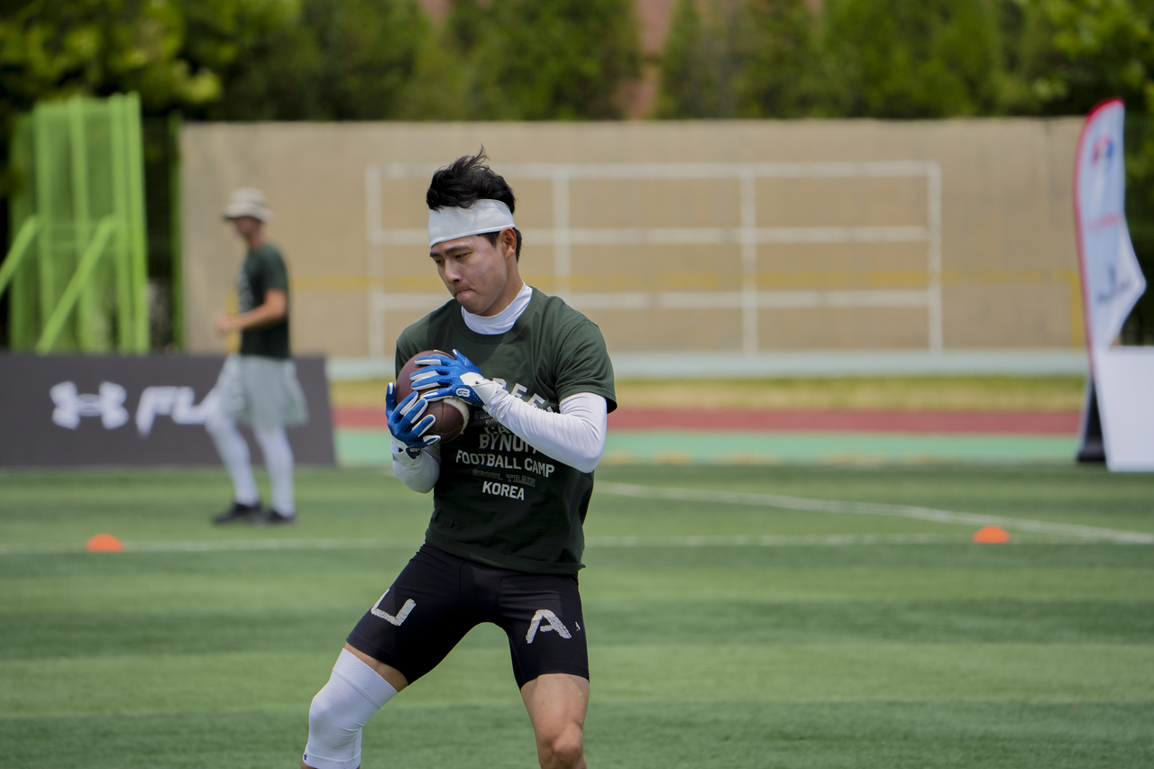 An athlete participates in a game of flag football on Friday during Camp Beezy Volume 6: Seoul Train, held between Friday and Sunday at Yonsei University's International Campus in Incheon. (Bynum Faith Foundation)