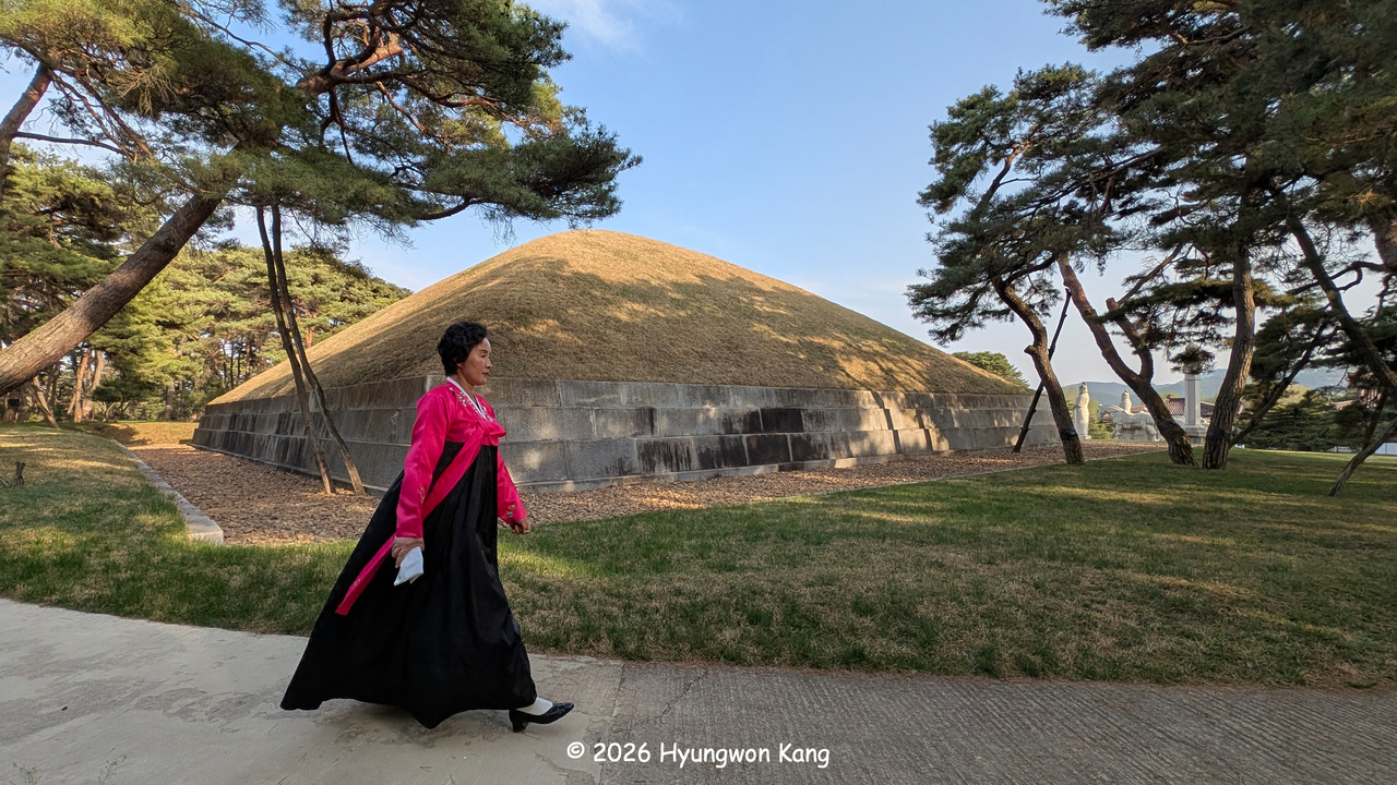 Kim Hyesung, a docent at the Complex of Koguryo Tombs, walks past the Tomb of King Dongmyeong (Jumong), the founder of Goguryeo, near Pyongyang. (Hyungwon Kang)