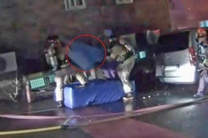 Toddler dropped from burning building caught safely by firefighters