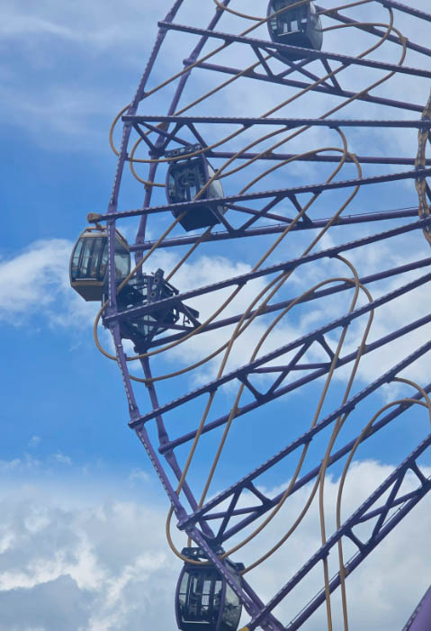 A gondola car from the Time Rider Ferris wheel at Gyeongju World is seen derailed and hanging after falling from its track. [Captured from X]