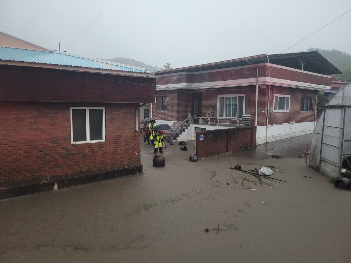 Homes are flooded in Cheongju, North Chungcheong Province, on Thursday. (Yonhap)