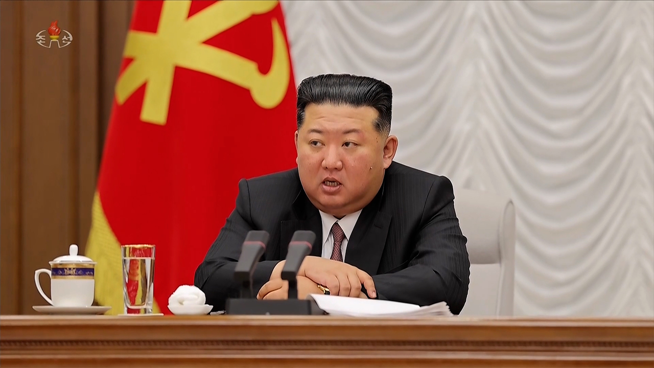 North Korean leader Kim Jong-un presides over the First Enlarged Meeting of the Ninth Central Military Commission of the Workers’ Party of Korea and signs seven written orders on Thursday, in this image aired by Korean Central Television the following day. (KCTV-Yonhap)