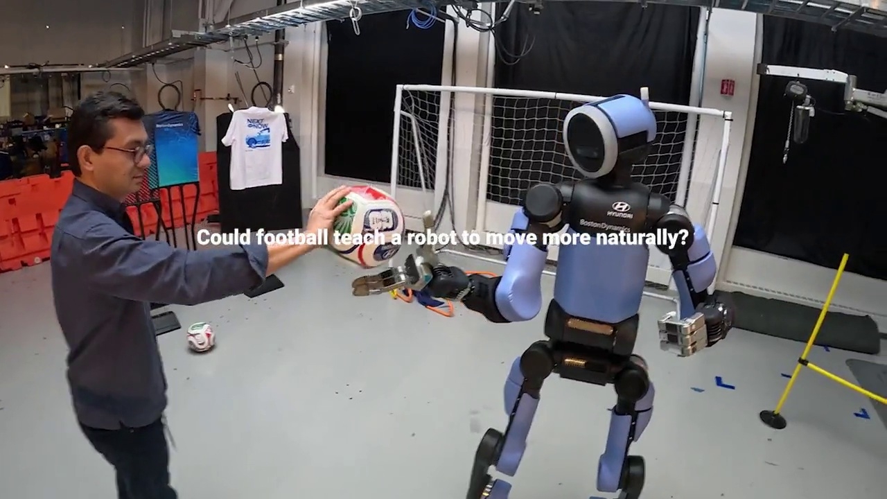 A Boston Dynamics researcher trains Atlas in football skills. [Hyundai Motor]