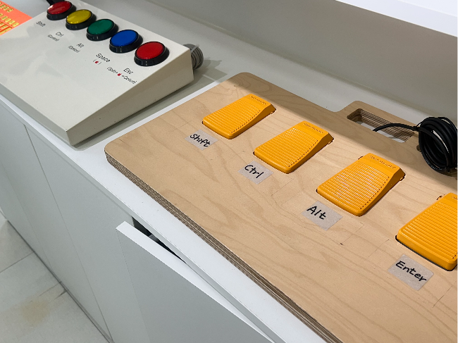 Foot pedals allow users to operate keyboard shortcuts using shift and control, helping people with limited hand mobility type and navigate a computer with one hand. (Choi Jeong-yoon/The Korea Herald)