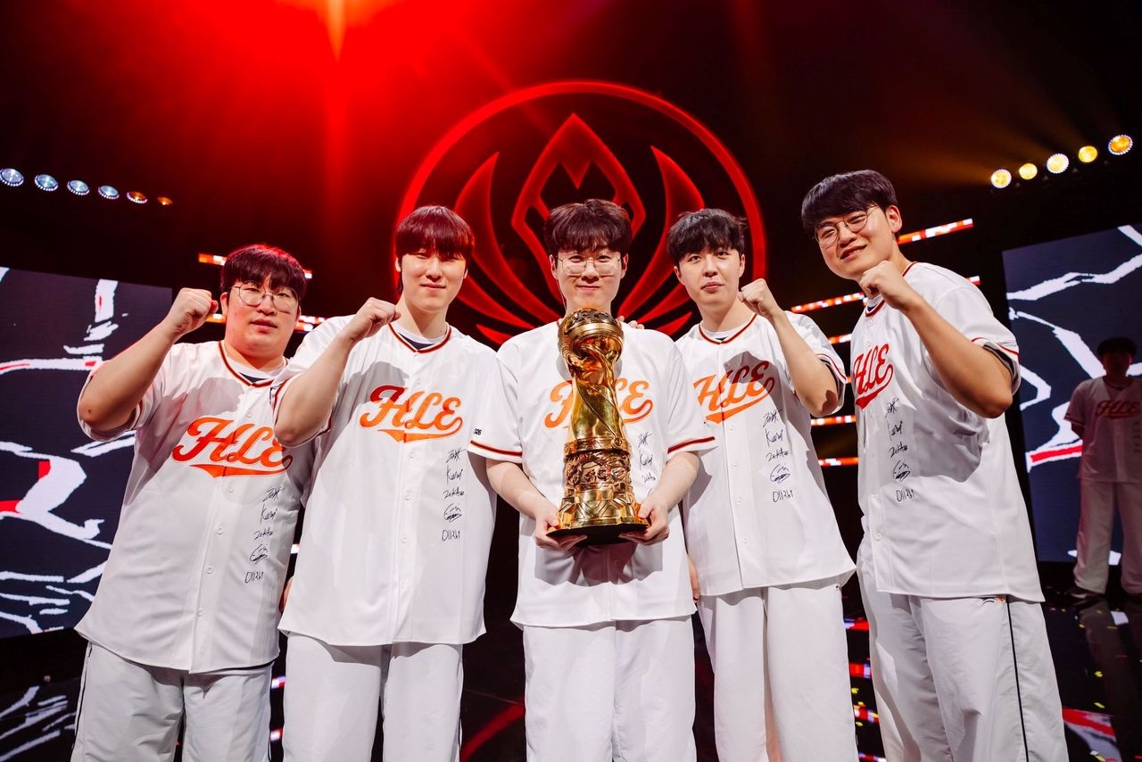 Hanwha Life Esports players (from left) Yu "Delight" Hwan-joong, Kim "Zeka" Geon-woo, Choi "Zeus" Woo-je, Seo "Kanavi" Jin-hyeok and Lee "Gumayusi" Min-hyung pose with the trophy after claiming the 2026 Mid-Season Invitational title in Daejeon on Sunday. (Riot Games)