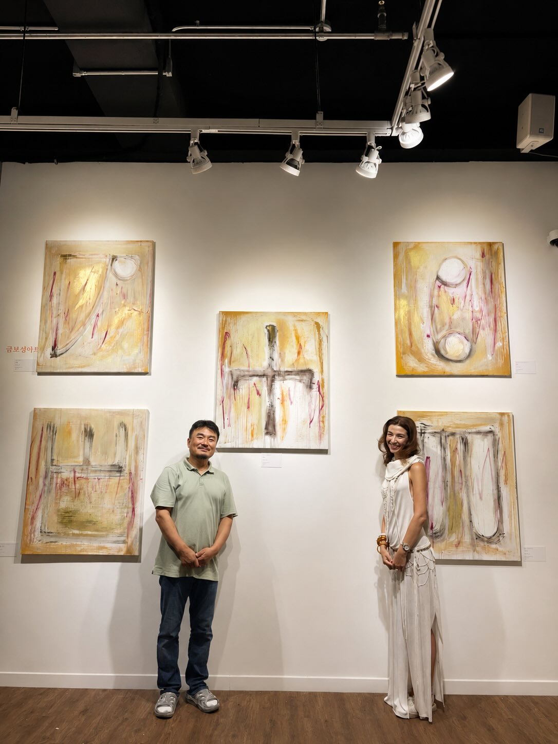 Patron poses with Geum in front of her paintings inspired by the Glagolitic alphabet. (Courtesy of Patron)