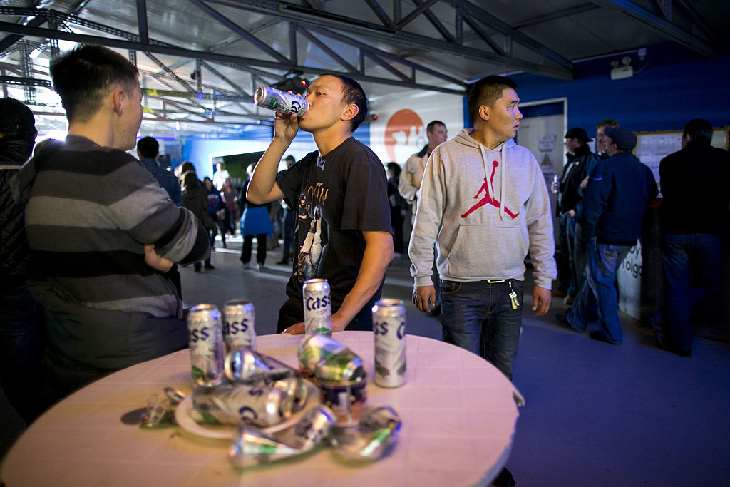 Mongolian and international workers drink Cass at a bar in Mongolia. (Getty Images)