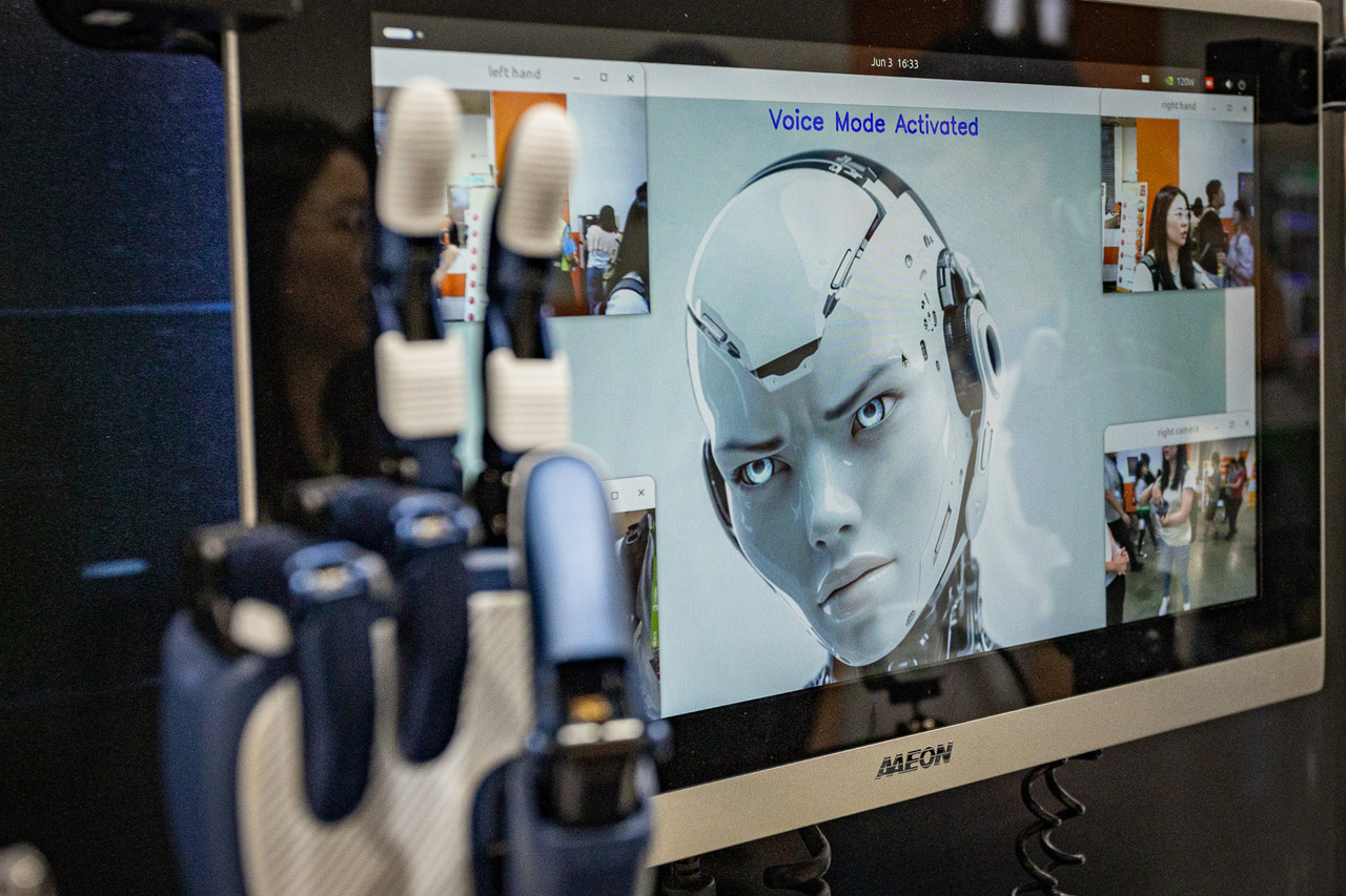 An interactive artificial intelligence display system showing an AI interface with “Voice Mode Activated” is presented alongside a robotic hand controller on June 03, 2026 in Taipei, Taiwan. Running June 2~5 across four venues in Taipei‘s Nangang and Xinyi districts under the theme “AI Together”.  [Getty Images]