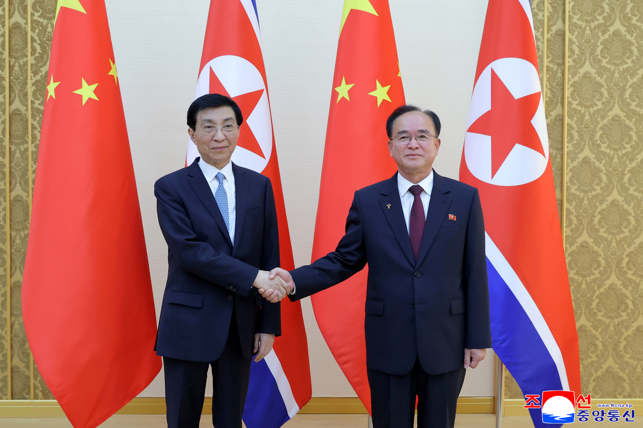 Jo Yong-won, a secretary of the Central Committee of the Workers' Party of Korea (R), and Wang Huning, chairman of the Chinese People's Political Consultative Conference, pose for a photo at their talks in Pyongyang on Wednesday. (KCNA via Yonhap)