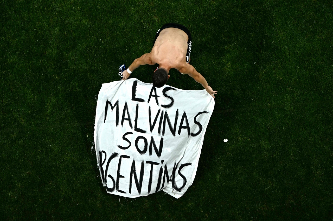 Argentina's midfielder Giovani Lo Celso adjusts a banner reading "Las Malvinas son Argentinas" ("The Falklands are Argentine") after winning the 2026 World Cup soccer tournament semifinal match between England and Argentina at the Atlanta Stadium in Atlanta on Wednesday. (AFP-Yonhap)