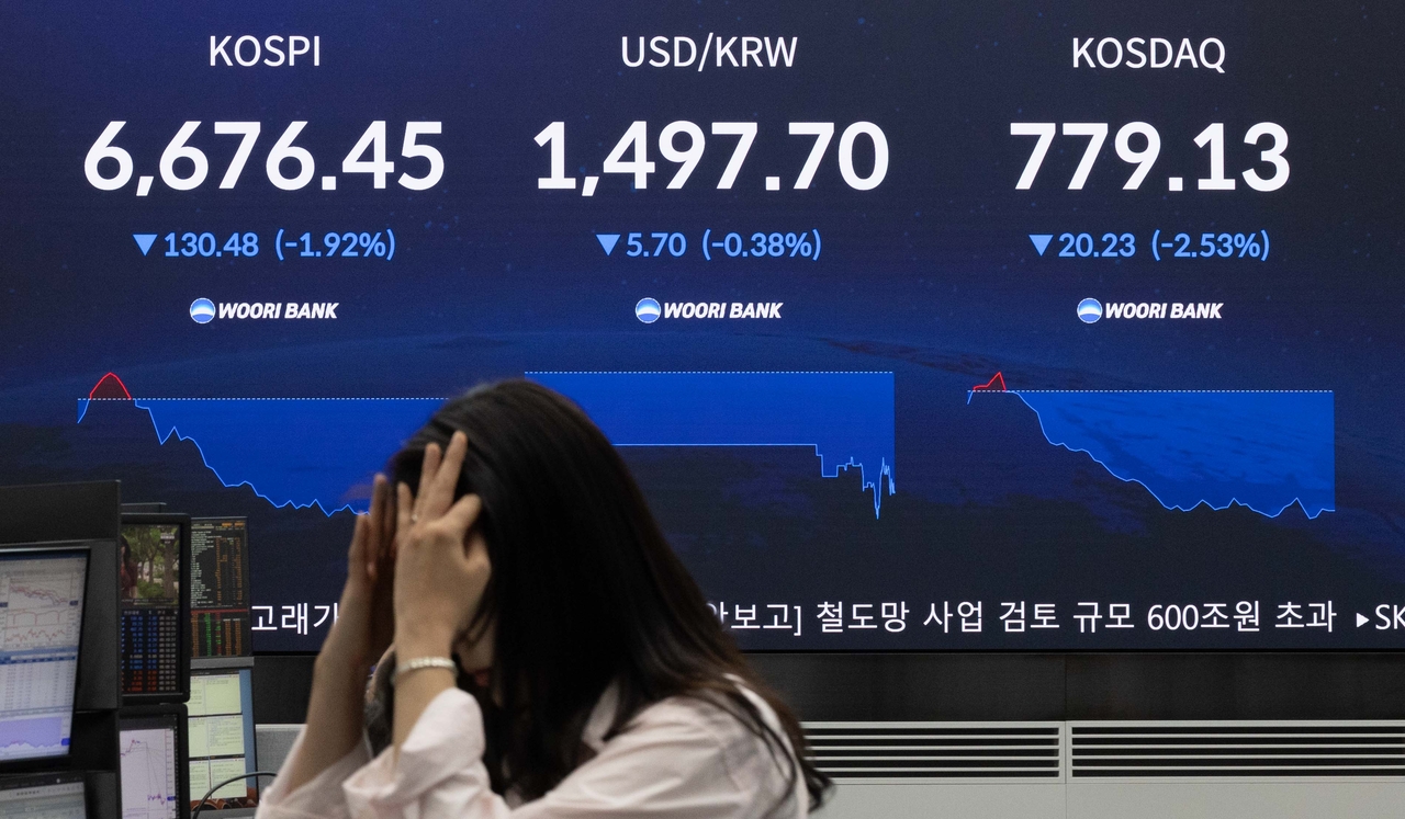 The Kospi index and other major market indicators are displayed at the Woori Bank dealing room in Jung-gu, Seoul, on Tuesday. Yoon Chang-bin