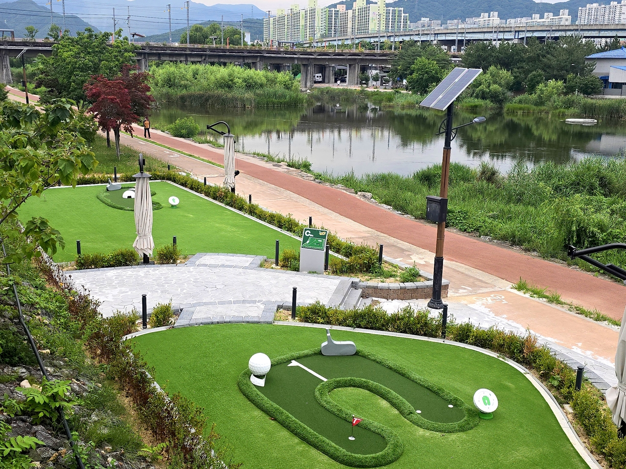The abandoned railway bridge over the Jeoncheon riverside, now transformed into a mini-golf course and garden