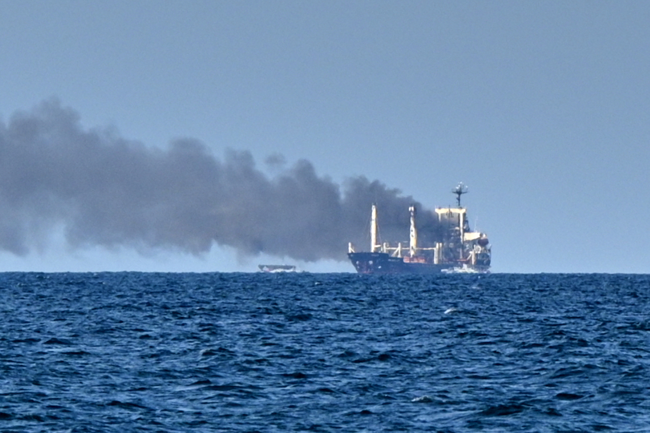 Smoke rises from the grain carrier Golden Leo under the Guinea-Bissau flag after Russian missile strike in the Black Sea close to Odesa, Ukraine, Sunday. (AP-Yonhap)