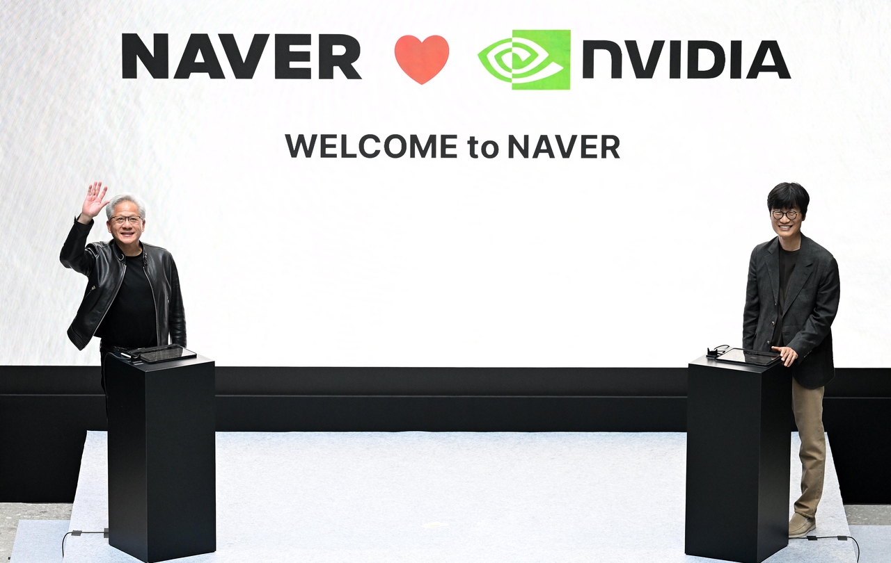 Nvidia CEO Jensen Huang (left) and Naver Chairman Lee Hae-jin appear onstage at Naver's 1784 building in Seongnam, Gyeonggi Province, on June 8, where the two companies set out plans to build gigawatt-scale AI factory capacity in Korea and abroad. (Lee Sang-sub/The Korea Herald)