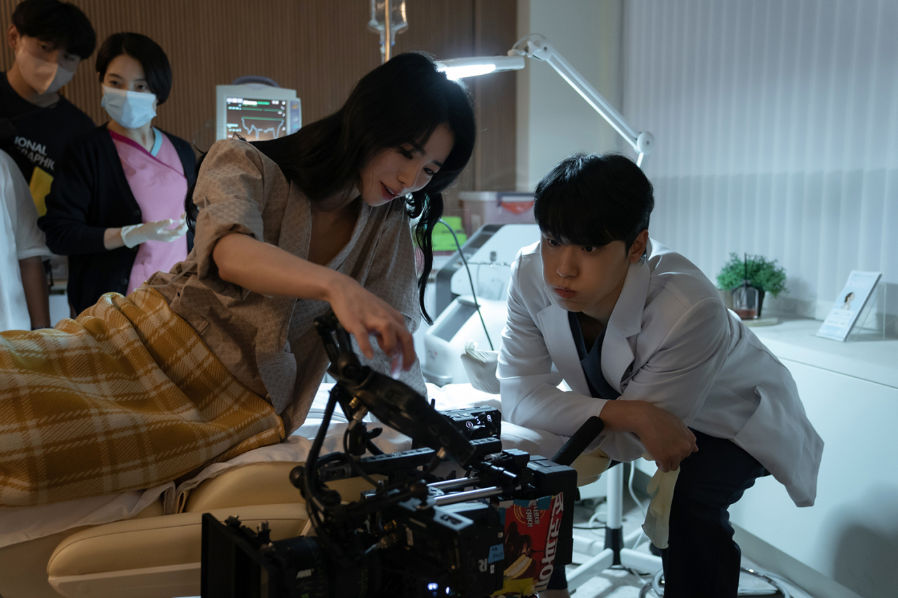 Lee Do-hyun (right) and Lim Ji-yeon discuss a scene on the set of "The Glory" in 2022. (Netflix)