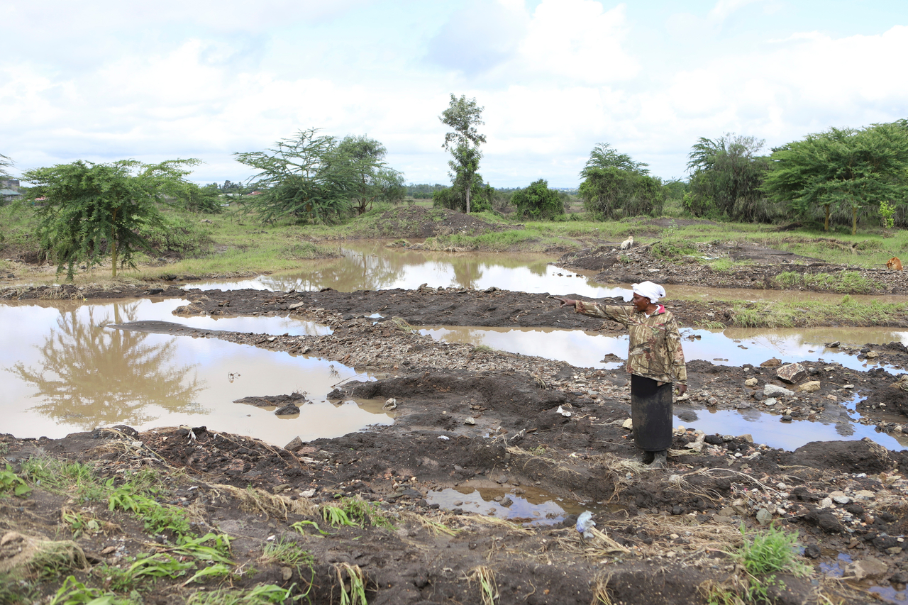 Martha Waema, stands on her farm after it was submerged by weeks of rainfall in Machakos, Kenya, May 8, 2024. (AP-Yonhap)