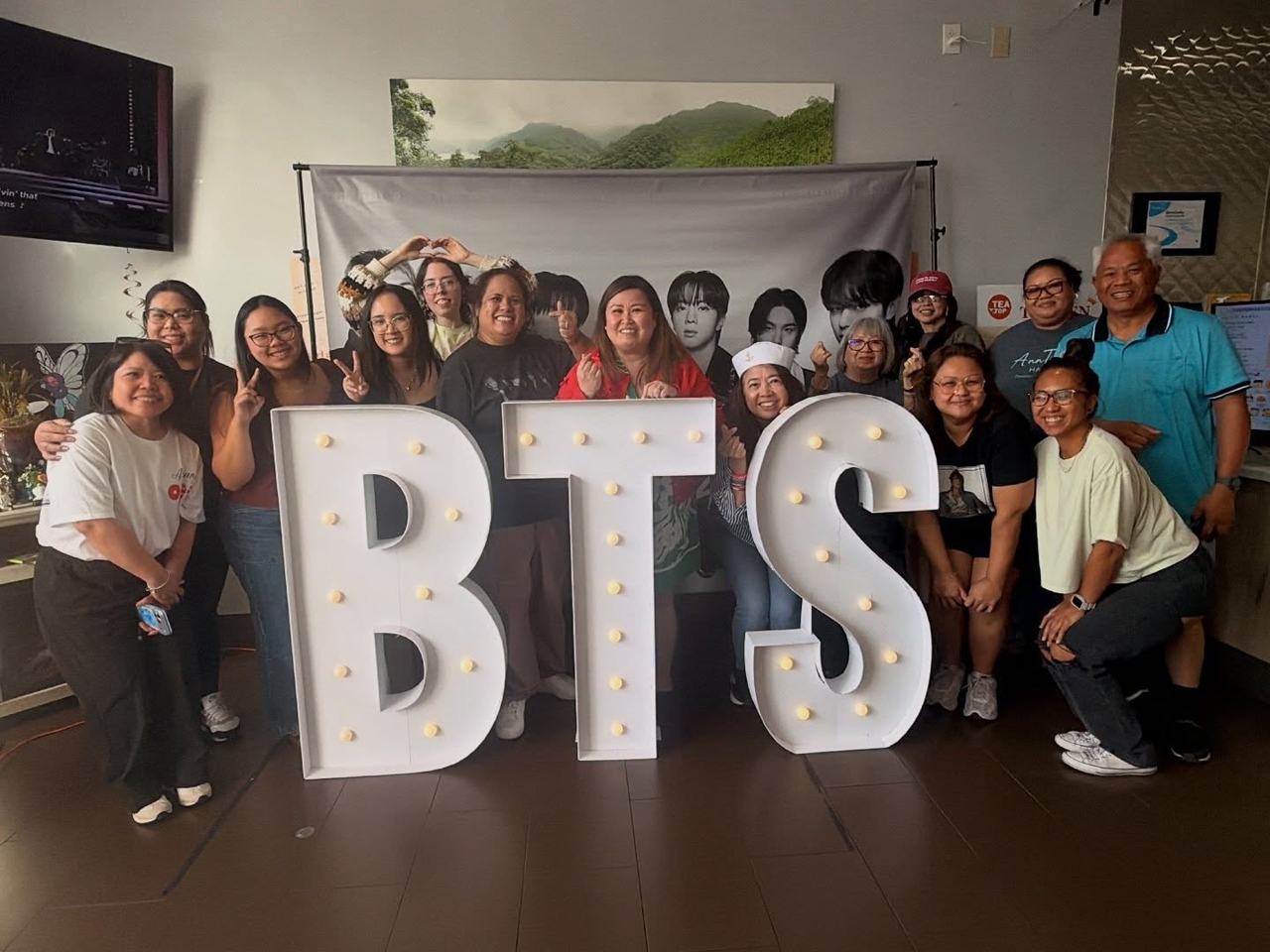 Carol Peregrino (center) poses with BTS Army Over 40 Club members at a cup sleeve event held in California in April. (Carol Peregrino)