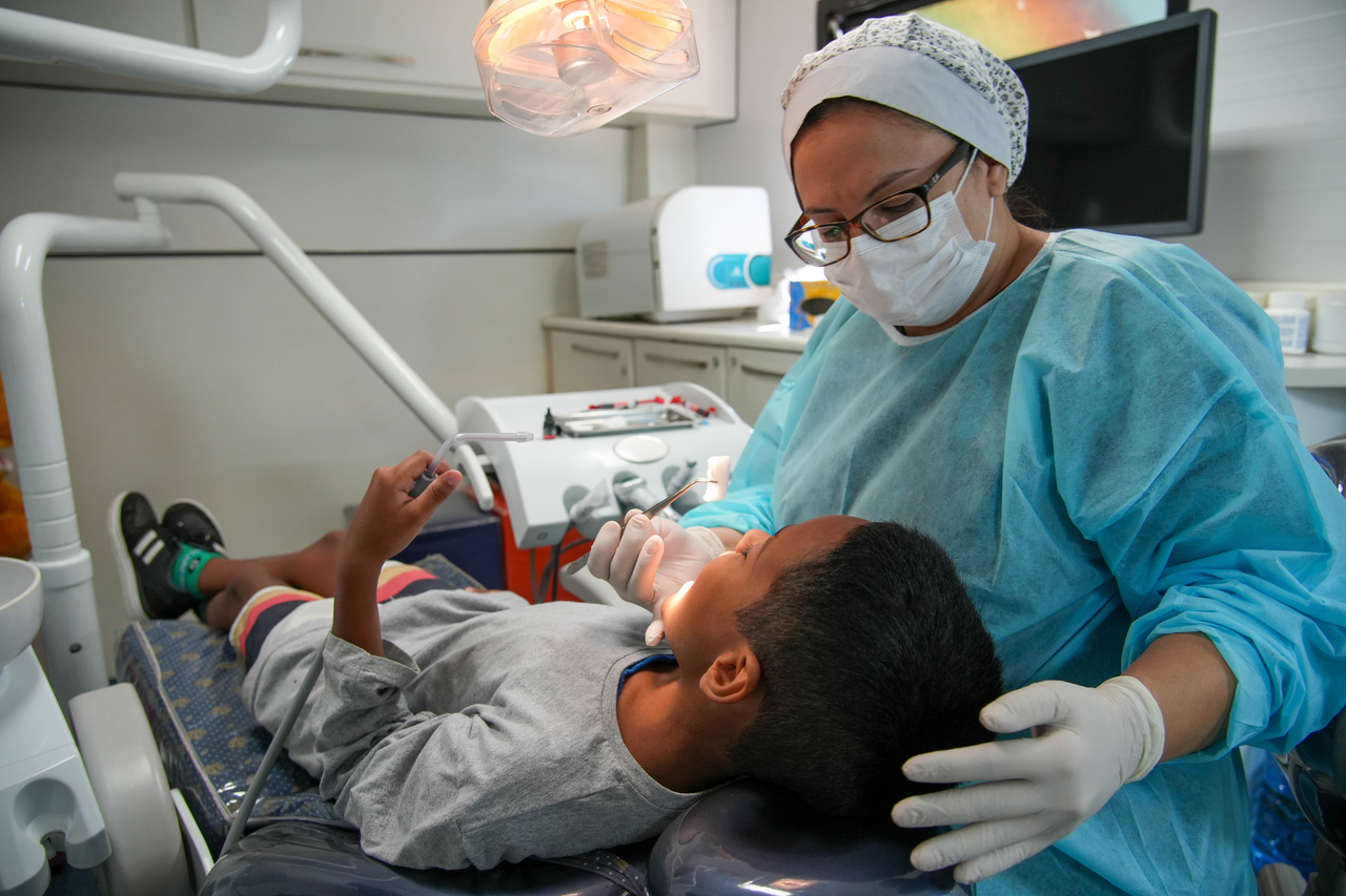 A local medical team treats a child inside a dental trailer as part of Hyundai Motor Brazil's mobile dental care project, Sorriso Cidadão. [Hyundai Motor Group]