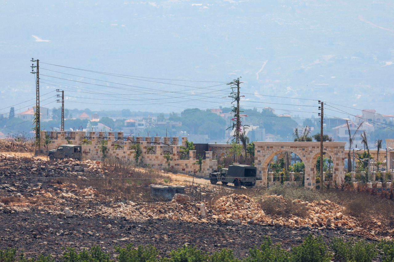 Military vehicles are on a road, as Lebanese army troops deploy in the area following the withdrawal of Israeli forces, under a US-brokered plan, in Zawtar al-Gharbiyeh, Lebanon, Wednesday. (Reuters-Yonhap)