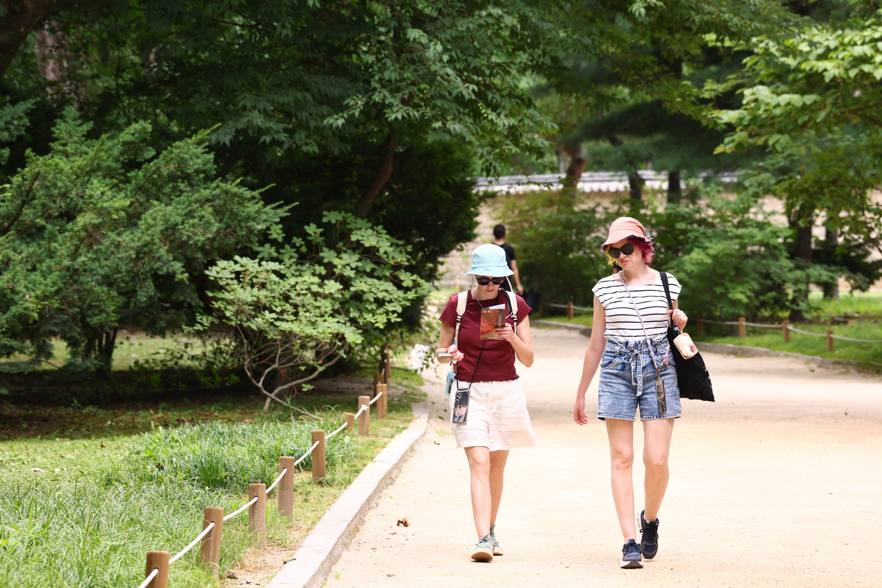 Visitors walk through Jongmyo Shrine, a popular heritage attraction in central Seoul, July 13. (Yonhap)