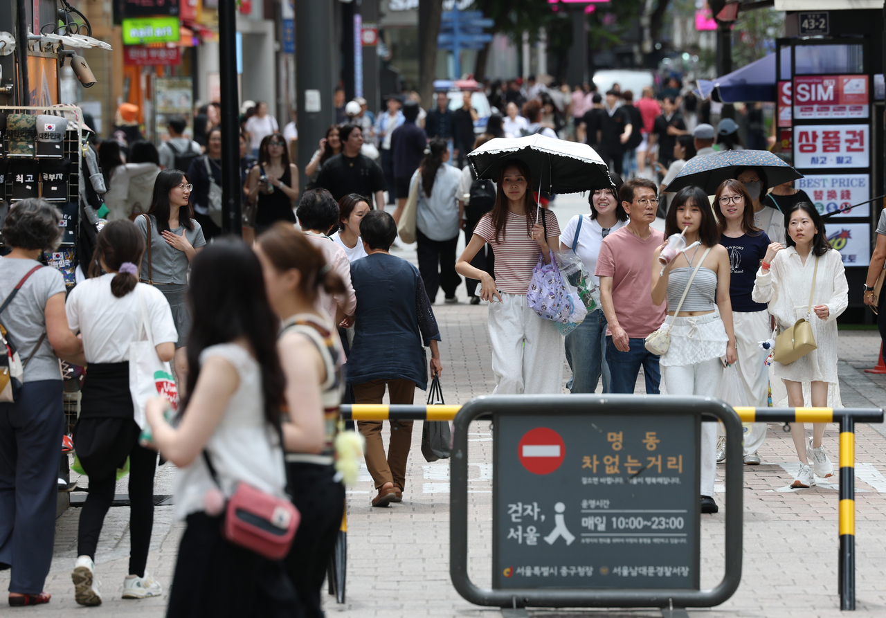 This photo taken June 24, shows a street at the shopping district of Myeongdong, central Seoul. (Yonhap)