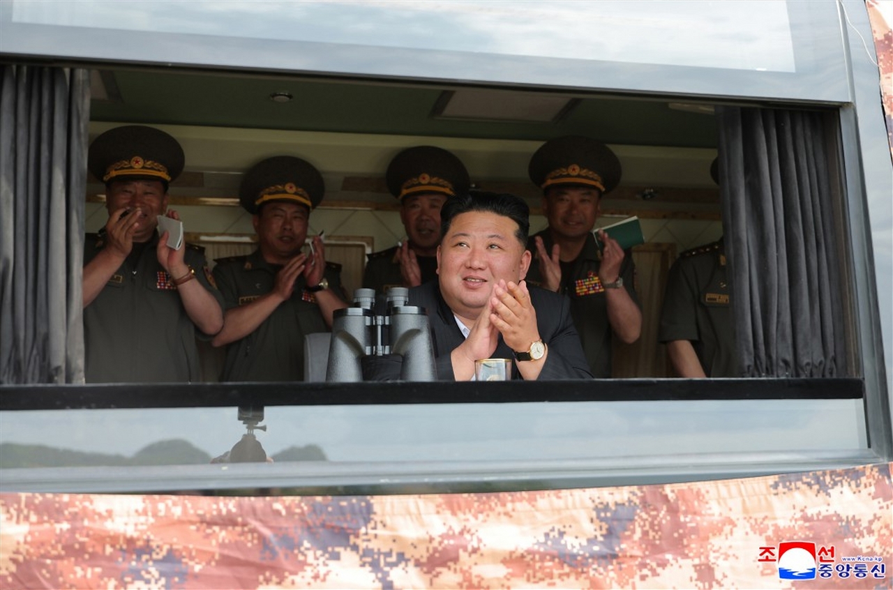 North Korean leader Kim Jong-un (front) watches a weapons test organized by defense science research institutes on June 25. (KCNA via Yonhap)