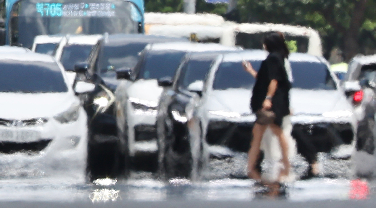 올여름 더위가 심상치 않다. ‘대프리카(대구와 아프리카의 합성어)’로 불리던 폭염 중심부가 경북 전역으로 확산되고 있다.  사진은 23일 울산에 이틀째 폭염경보가 발효 중인 가운데 남구 한 도로에 지열로 인한 아지랑이가 피어오르고 있는 모습. [연합]